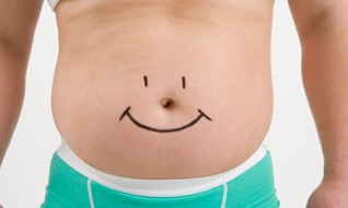 Overweight man with drawing of smiley face on stomach