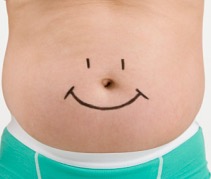 Overweight man with drawing of smiley face on stomach